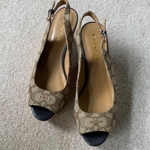 Coach wedge sandals in brown logo with gold logo on top. New without tags.